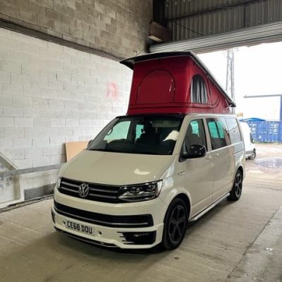 White camper with red pop top